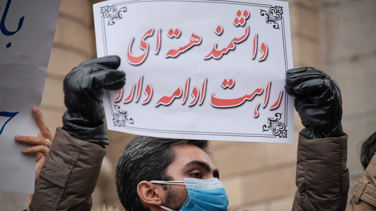 A protester holds a placard with a Persian script that said, The way of the nuclear scientist will be continue, while attending a protest gathering against the assassination of the Iranian Top nuclear scientist and a member of the Irans Islamic Revolution