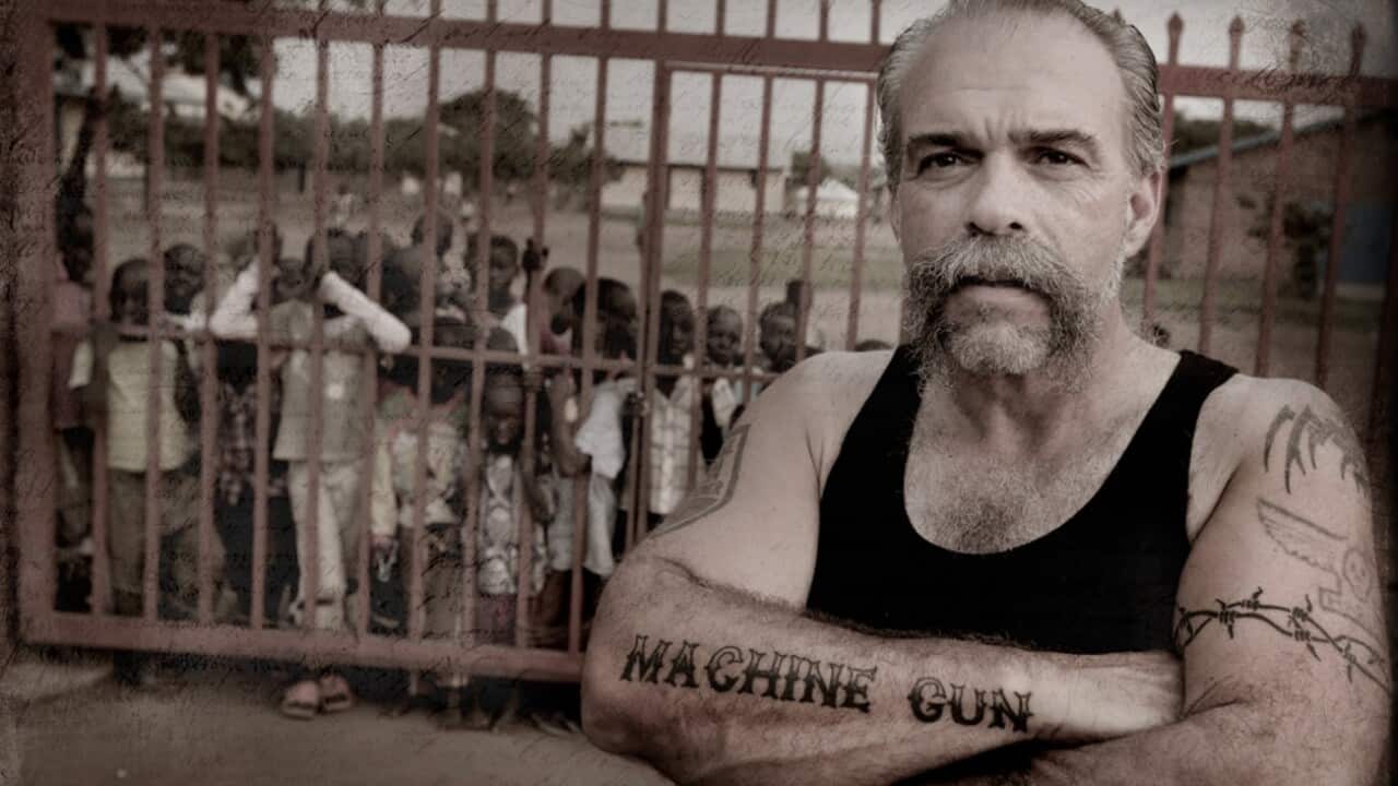 A supplied image obtained Thursday, August 17, 2017 of Machine Gun Preacher Sam Childers in 2013 standing outside the gates to one of the orphanages