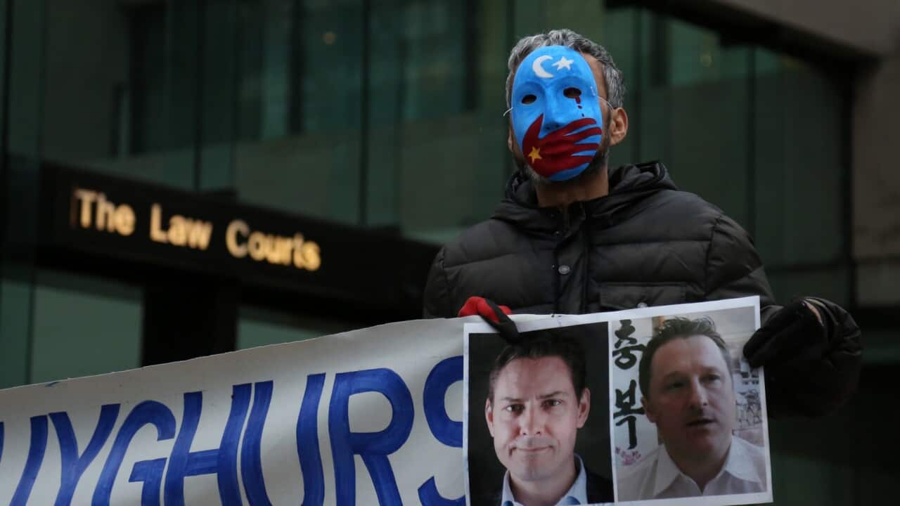 Activists protest China's treatment of Uighurs outside a court in Vancouver, Canada