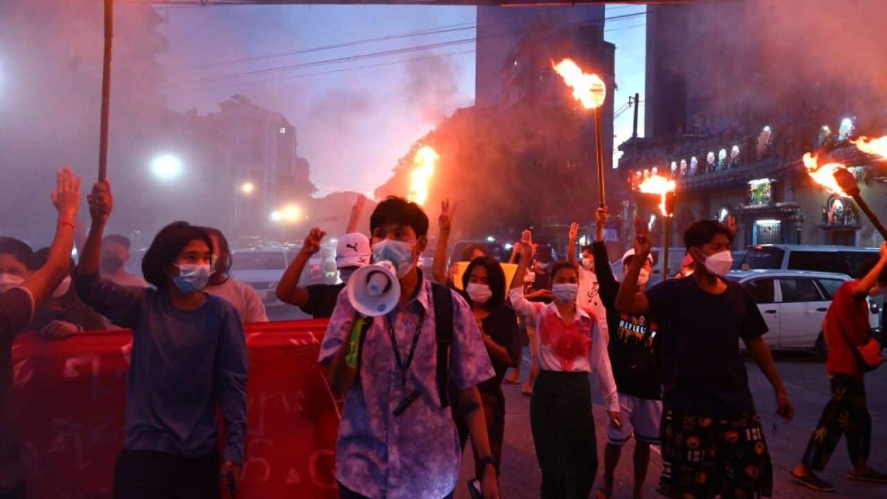 Protesters hold up the three-finger salute during a demonstration against the Myanmar military coup in Yangon on July 29, 2021.