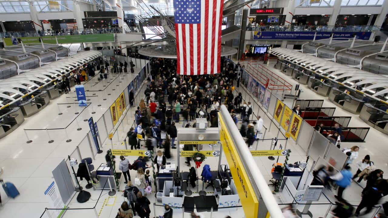 People walking through an airport.