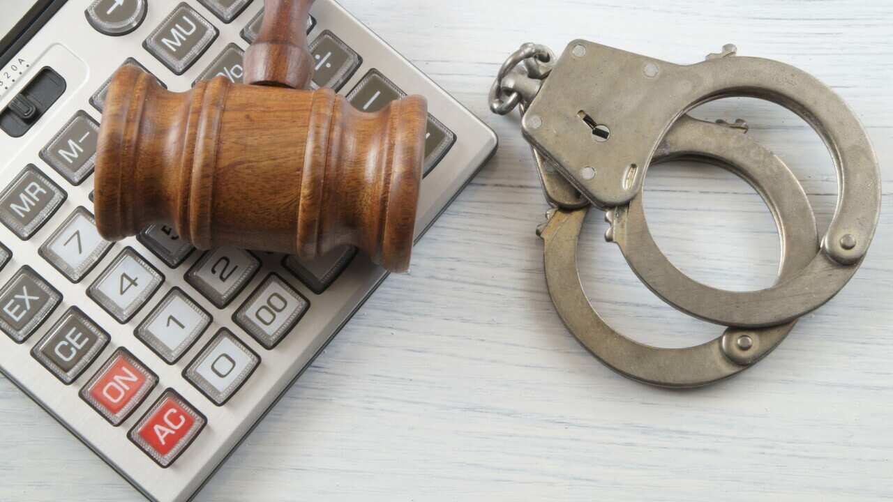Judge gavel with calculator and handcuffs