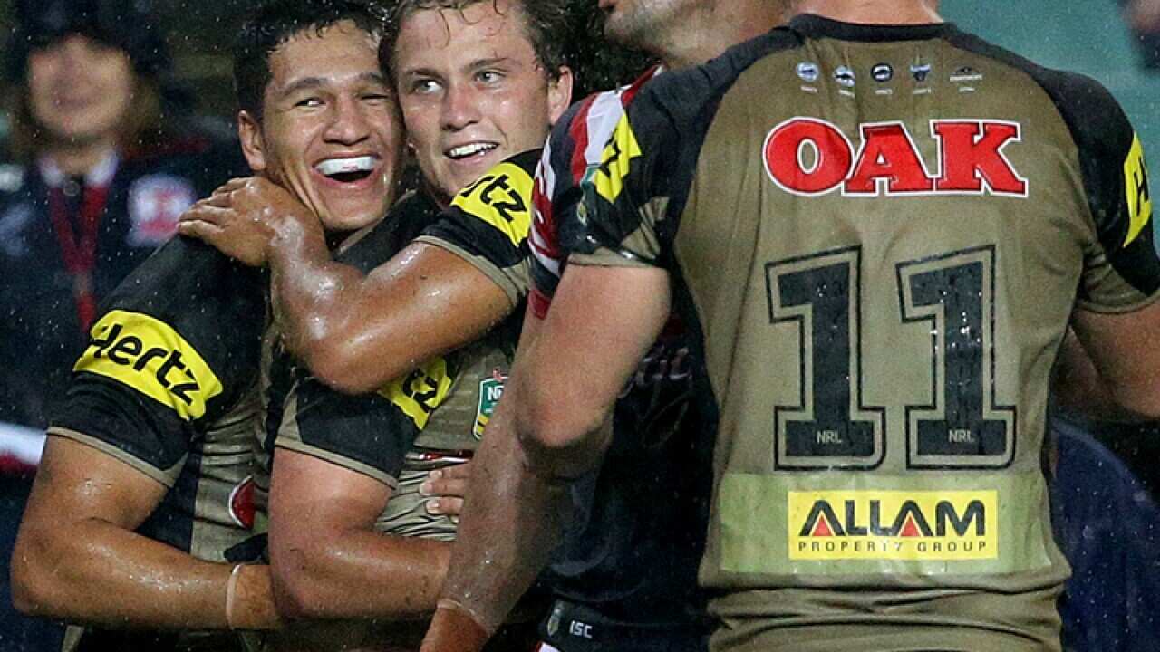 Penrith Panthers' Te Maire Martin (2L) celebrates