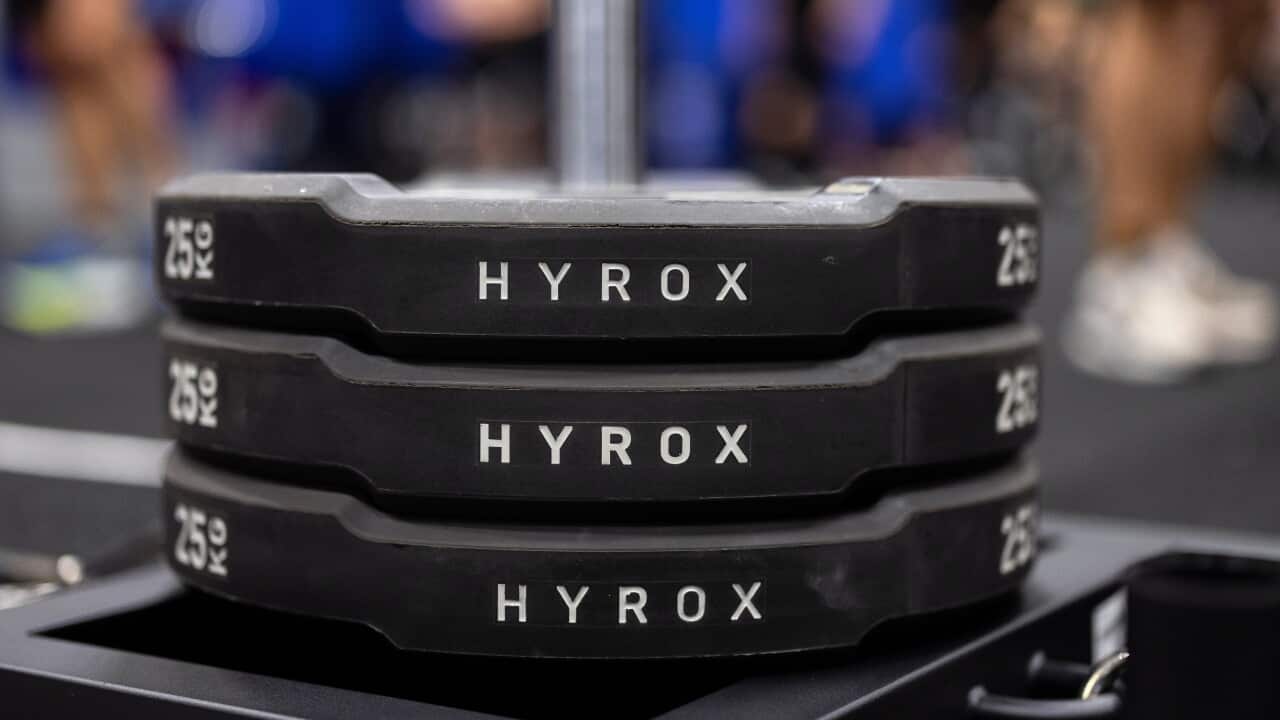 A stack of weights labelled HYROX.