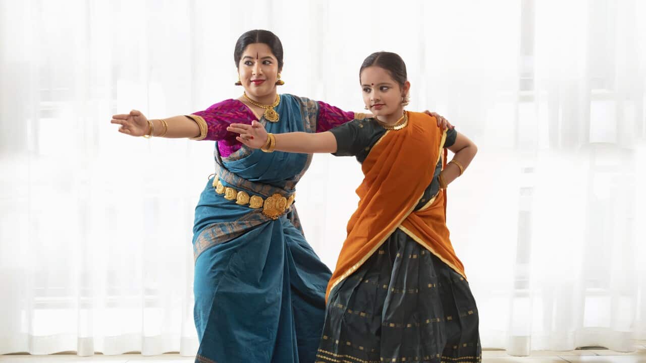Young bharatnatyam dancer learning from her teacher.