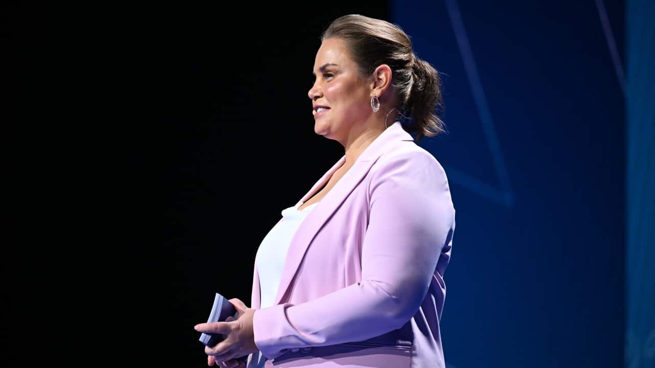 A woman in a purple suit.