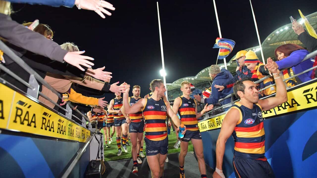Crows players head to the change rooms after the Round 18 AFL match between the Adelaide Crows and the Geelong Cats at Adelaide Oval in Adelaide, Friday, July 21, 2017. (AAP Image/David Mariuz) NO ARCHIVING, EDITORIAL USE ONLY