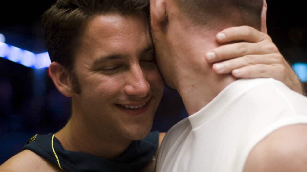 Partygoer Ariel Yesburg hugs a friend