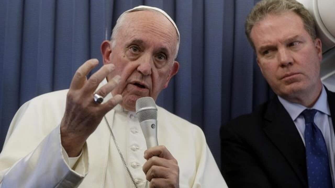 Pope Francis answering questions from reporters
