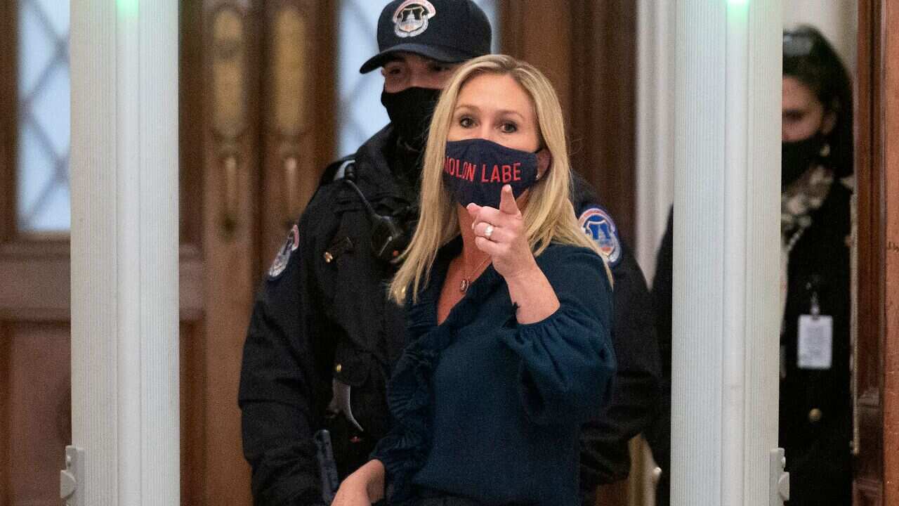 Representative Marjorie Taylor Greene shouts at journalists as she goes through security outside the House Chamber at Capitol Hill on 12 January, 2021.