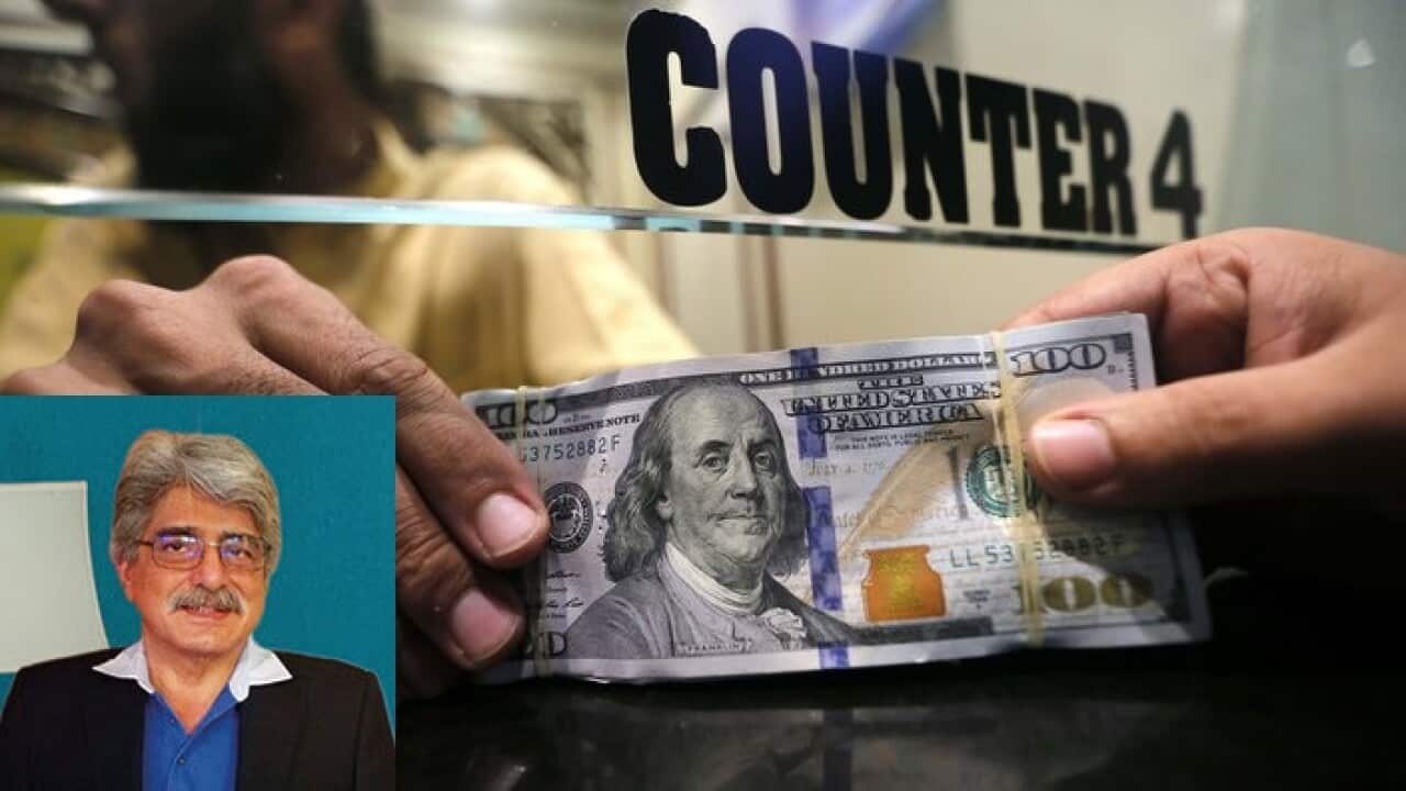 A currency exchange dealer sorts US Dollars in Peshawar, Pakistan