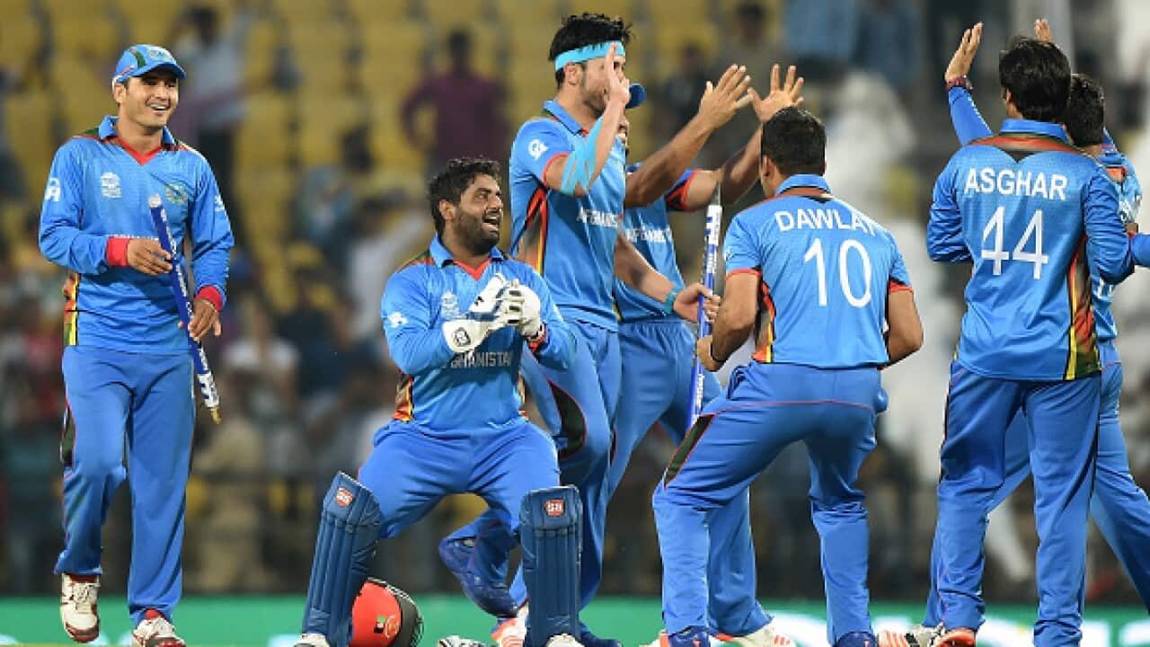 Afghanistan's players led by Mohammad Shahzad(C)celebrate after winning the World T20 cricket tournament match against West Indies