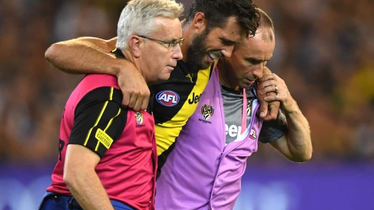Alex Rance of the Tigers (centre).