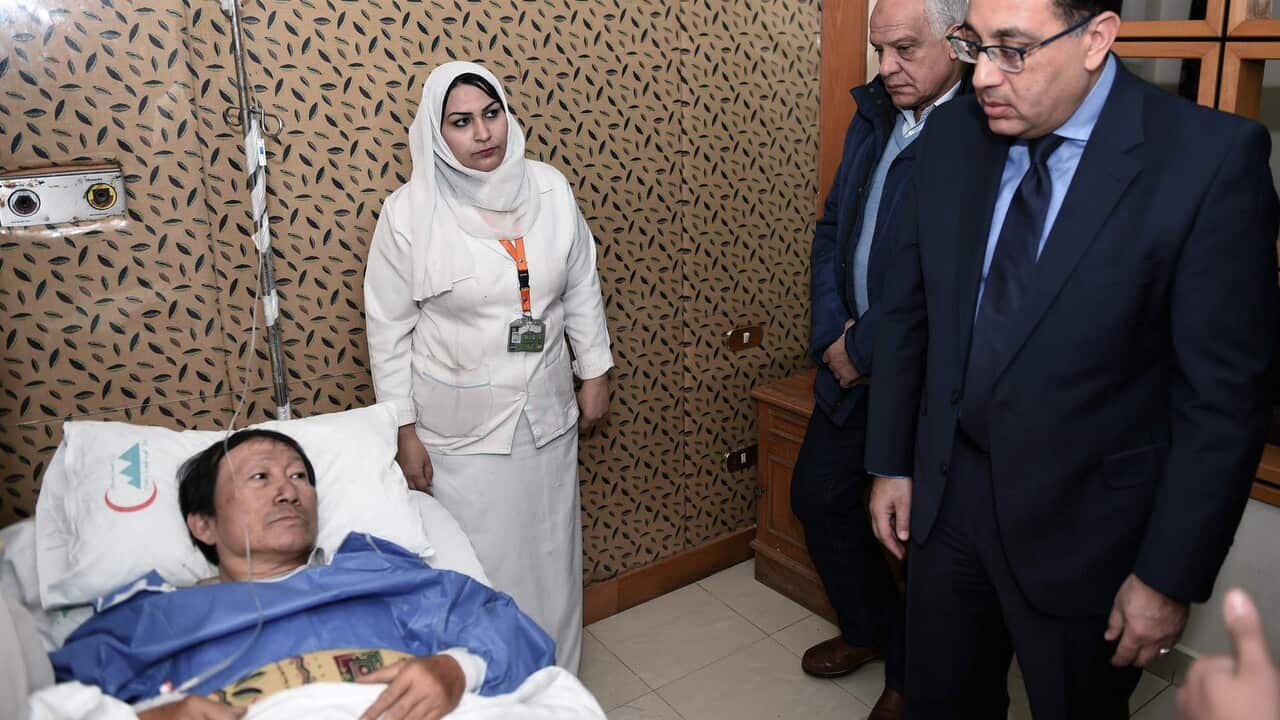 Egypts Prime Minister Moustafa Madboulyvisits a Vietnamese injured at a hospital after a bomb explosion, near Mariottia Corridor, Giza, Egypt.