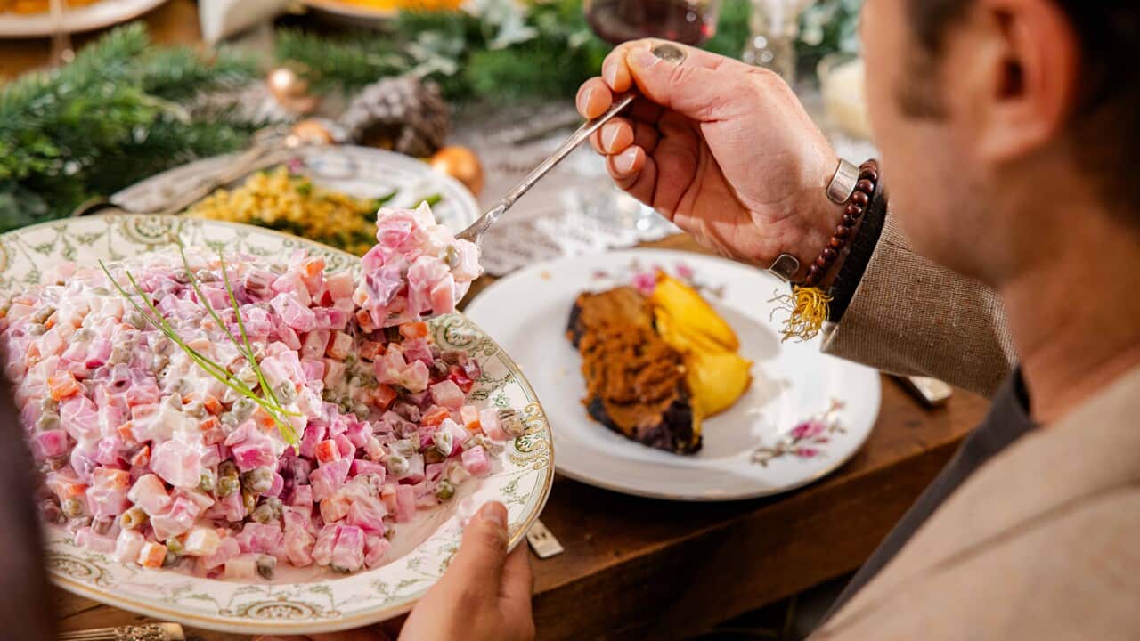 Insalata Russa getting spooned from a bowl in a dinner party setting