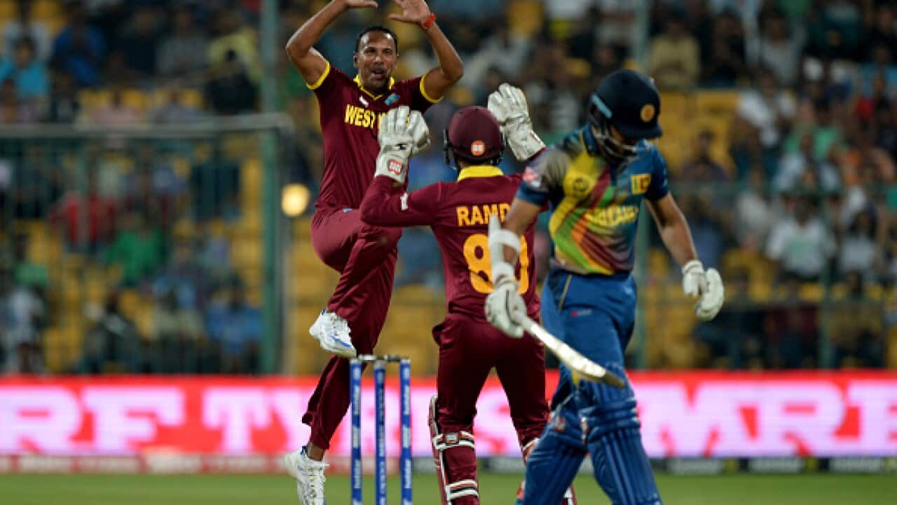 West Indies bowler Samuel Badree (L) celebrates the wicket of Sri Lankan batsman Milinda Siriwardana (R) with wicketkeeper Denesh Ramdin