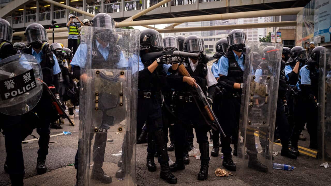 Hong Kong riot police prepare to deploy tear gas against protesters (AAP)