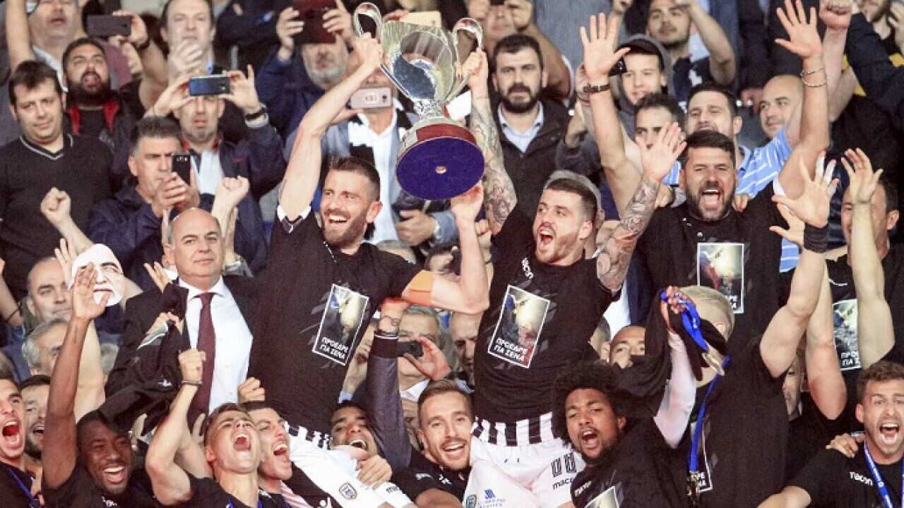 Nine-man PAOK beat champions AEK Athens 2-0 to clinch the Greek Cup.