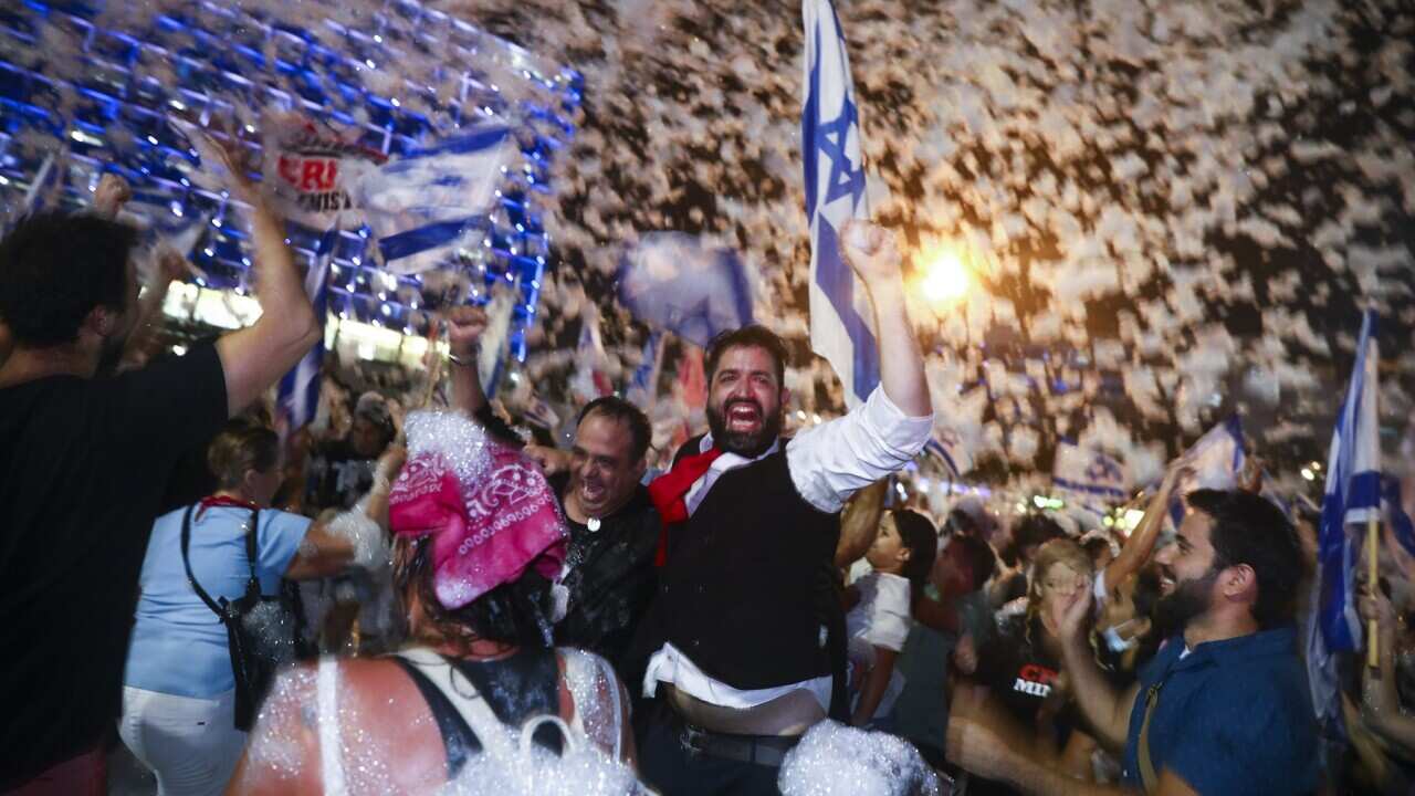 Israelis celebrate the swearing in of the new government in Tel Aviv, Israel