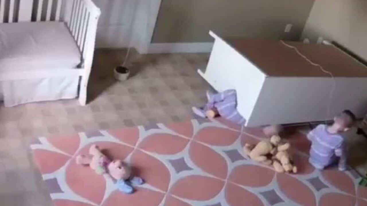 Toddler rescuing twins from dresser falling