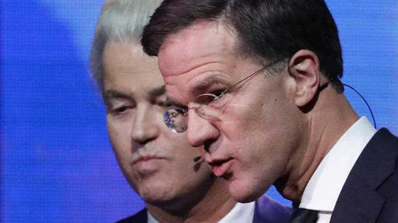Right-wing populist leader Geert Wilders and Dutch Prime Minister Mark Rutte, right