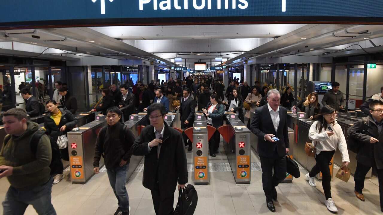 Commuters are seen at Town Hall train station in Sydney, Friday, August 23, 2019. A train breakdown at Town Hall station is causing delays on the network. (AAP Image/Peter Rae) NO ARCHIVING