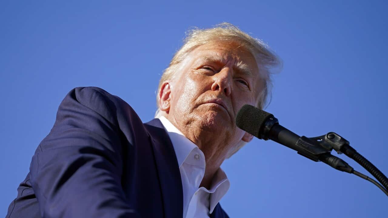 Former President Donald Trump speaks into a microphone at a campaign rally at Waco Regional Airport on 25 March 2023.
