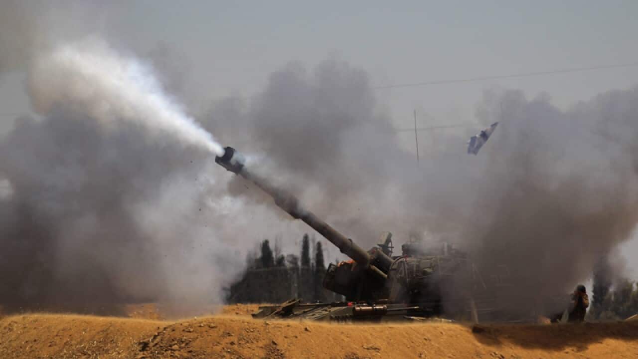 An Israeli tank fires towards the Gaza Strip