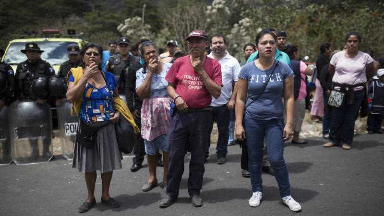 Relatives wait outside the Virgen de la Asunción children's shelter, in San Jose Pinula, Guatemala, on Wednesday, March 8, 2017.