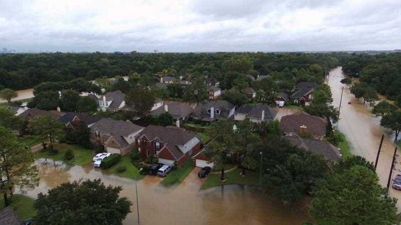 Volunteers help pull a rescue boat in from sweeping currents in floodwaters in the aftermath of Harvey in Beaumont, Texas on Wednesday, Aug. 30, 2017.