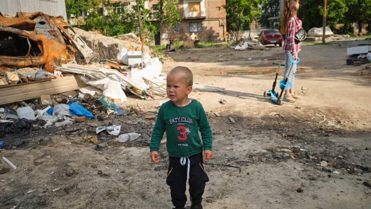 A boy walks through the wreckage of a destroyed building. As the city of Kiev tries to return to normality, the streets are a reminder that the war is still raging.
