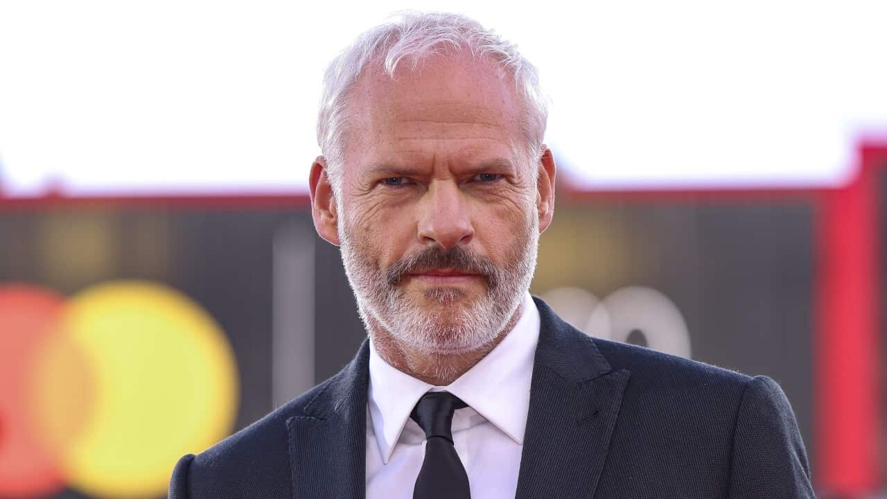 A man in a blue suit and tie.