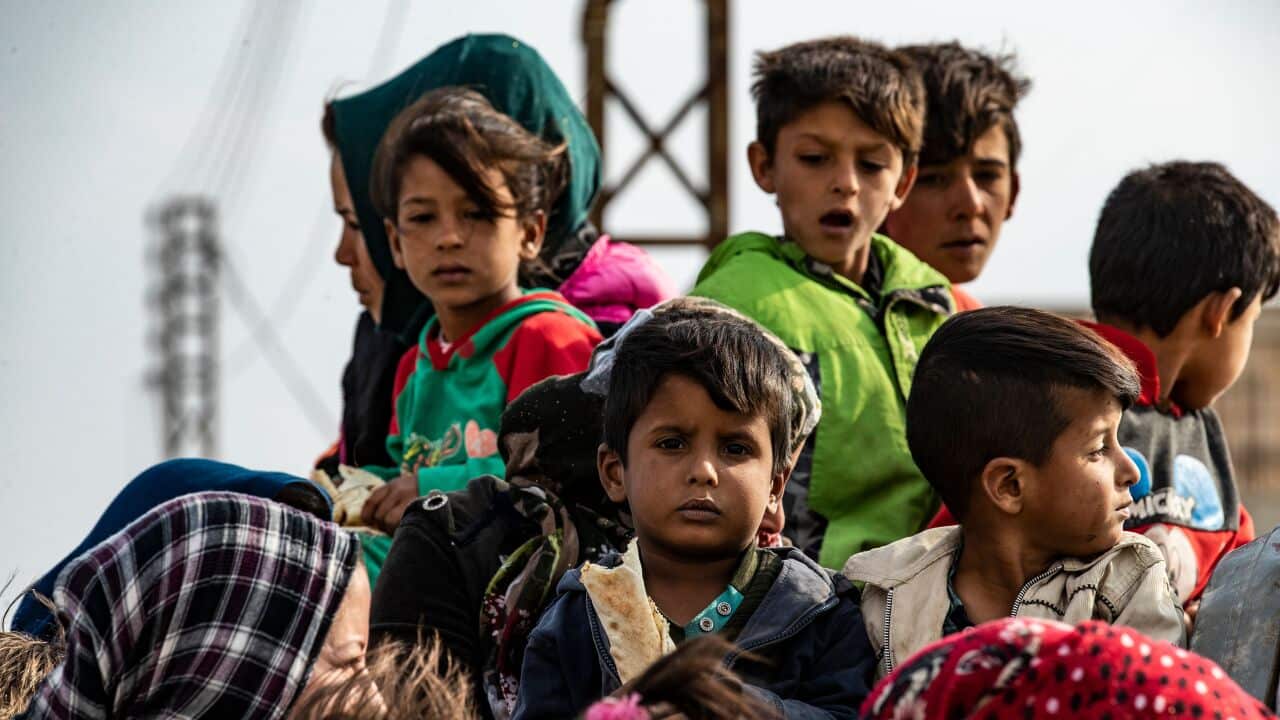 Syrians flee the countryside of the northeastern Syrian town of Ras al-Ain on the Turkish border, toward the west to the town of Tal Tamr on October 19, 2019.