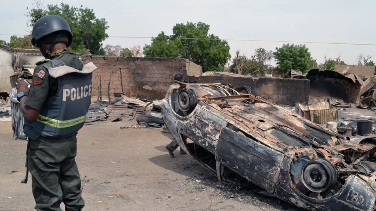Burned out cars and houses following an attack in Kawuri
