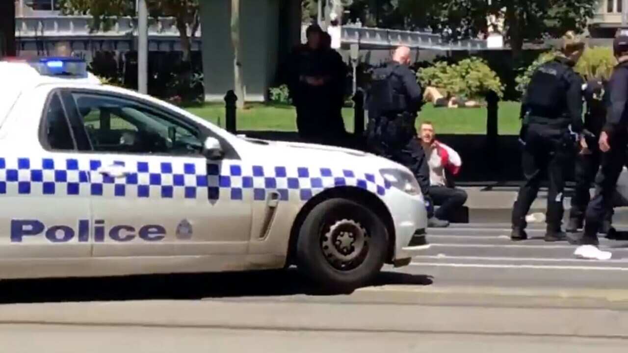 Victoria Police question the alleged driver on the side of the road.