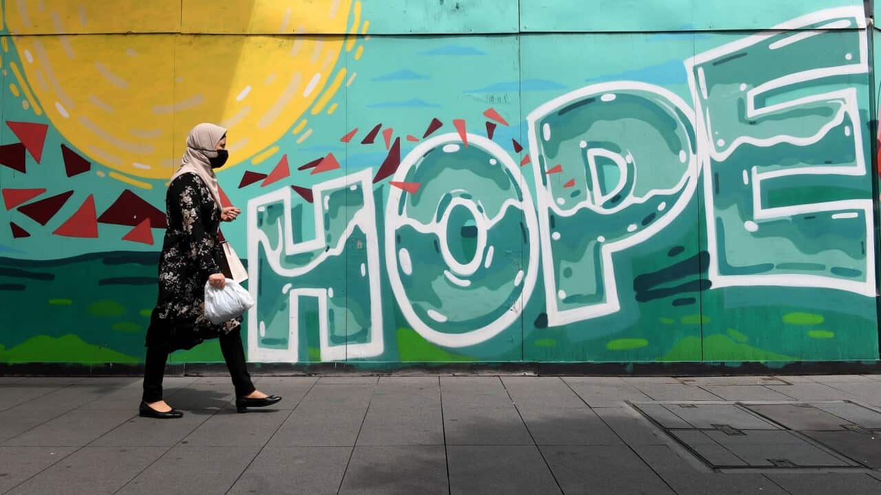 Members of the public wear face masks as they go about their daily lives in Liverpool, Sydney,