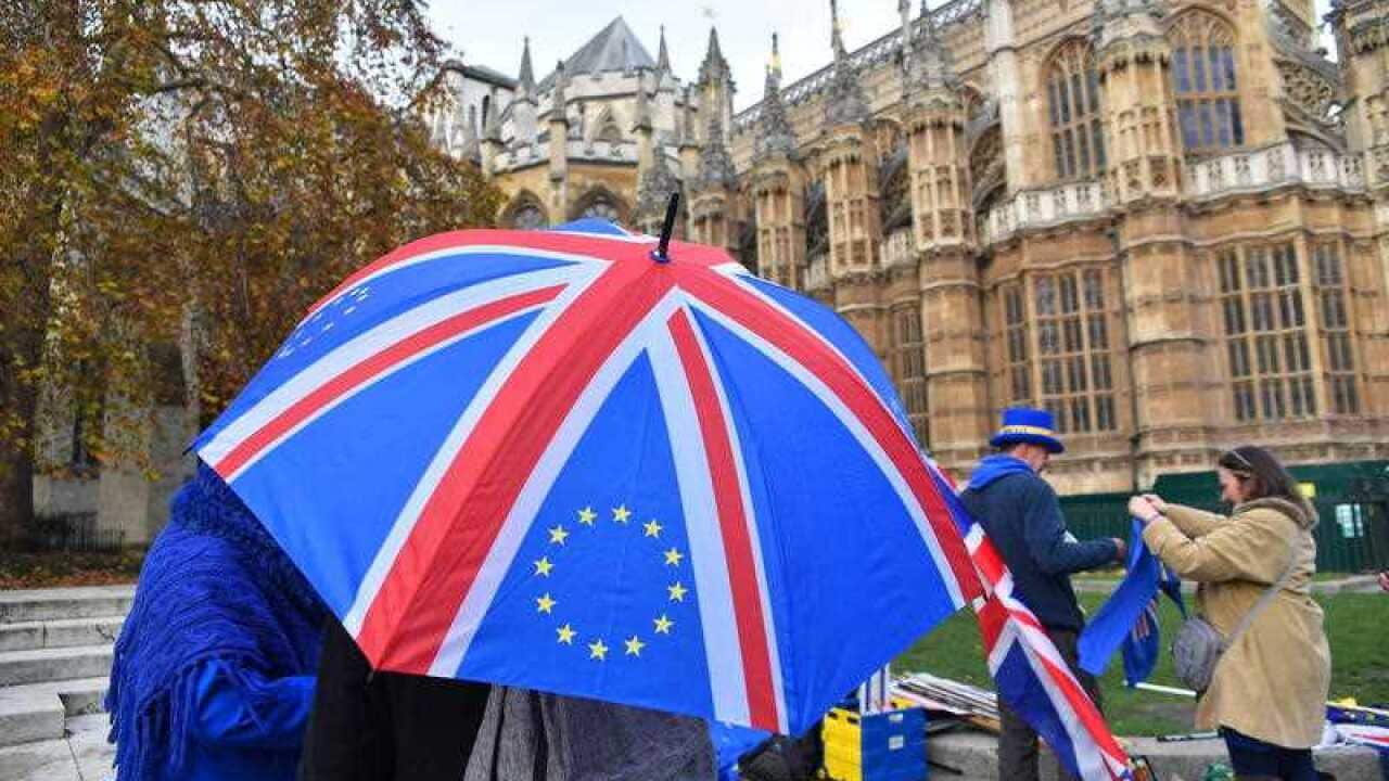 EU and Union flags are waved outside the Parliament to protest against Brexit.