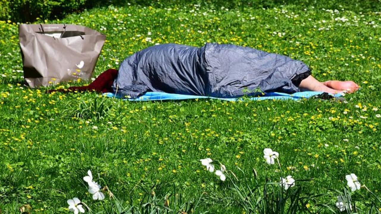 A homeless person sleeping in the open