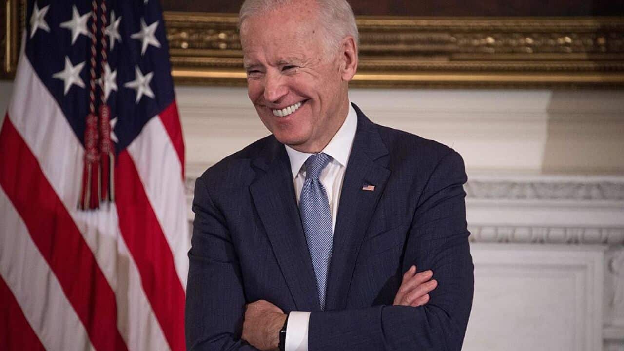 US Vice President Joe Biden laughs as President Barack Obama speaks.