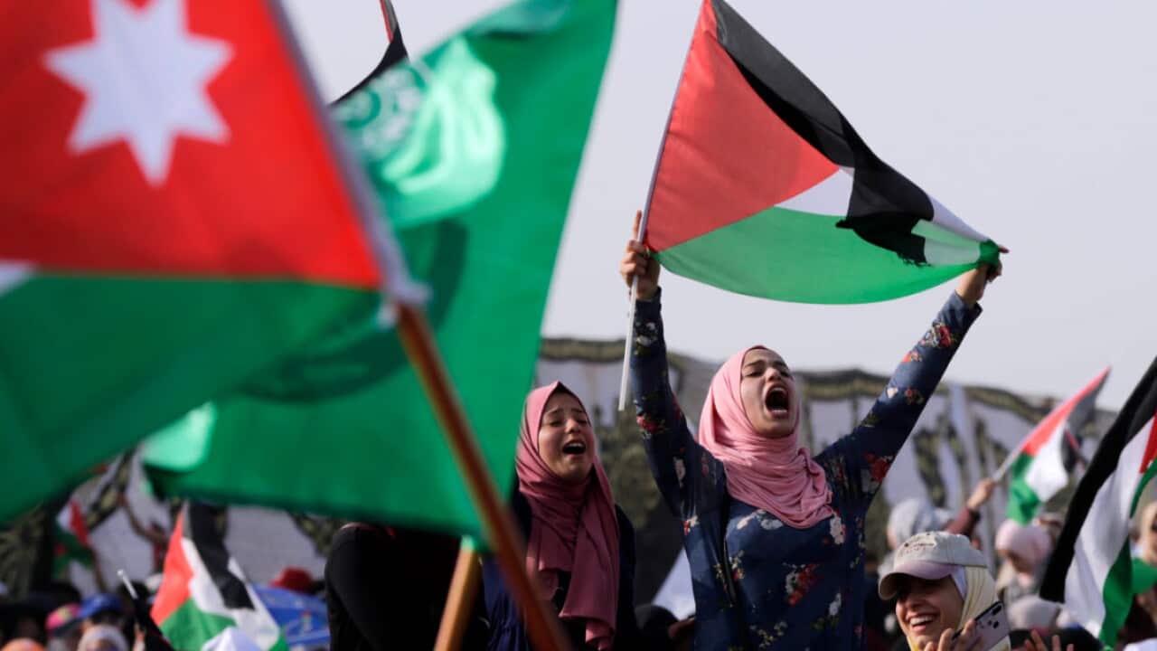 Protesters from the Muslim Brotherhood hold flags and shout slogans in support of the King of Jordan and his Custodianship over holy sites in Jerusalem, at the Dead Sea, near Amman, Jordan, 26 April 2019 (AAP)
