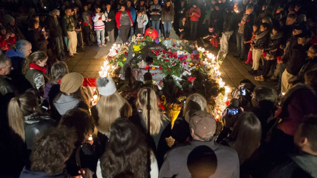 People at the Tomb of the Unknown Soldier during a candlelight vigil