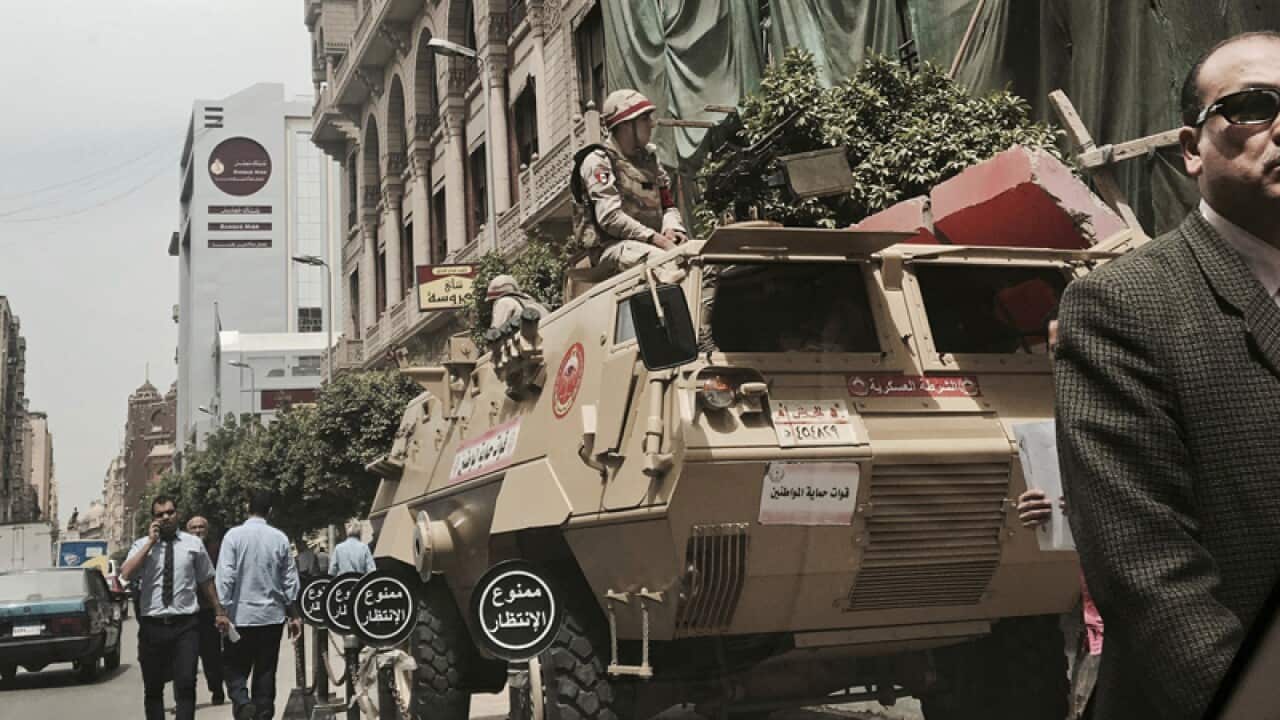 Military soldiers guar a street near a church in Cairo, Egypt