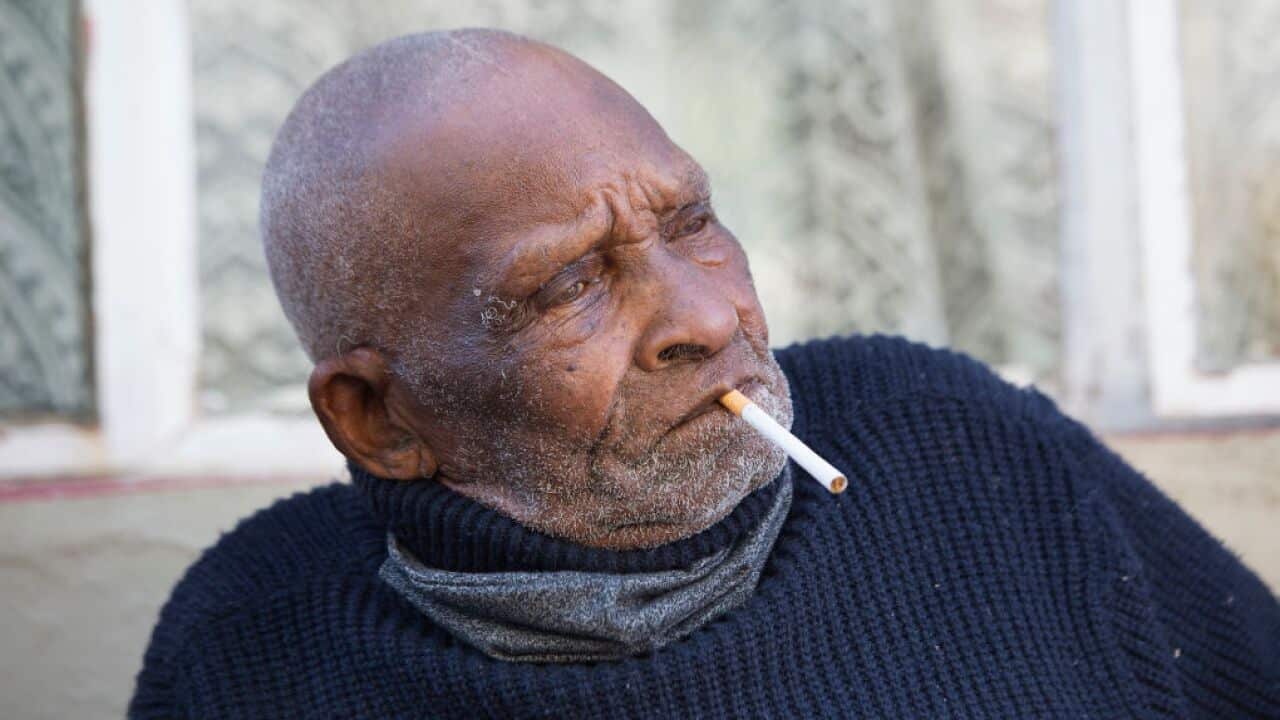 Fredie Blom enjoys a cigarette as he celebrates his 116th birthday at his home in Delft, near Cape Town, South Africa.