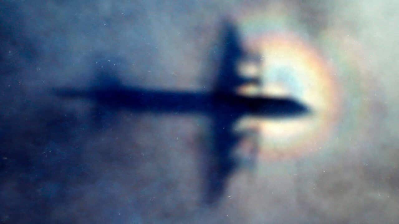 The shadow of a Royal New Zealand Air Force P3 Orion on low cloud while the aircraft searches for missing Malaysia Airlines Flight MH370