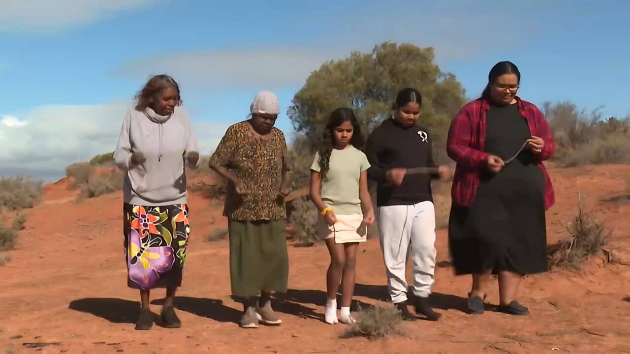 Artist Juanella Donovan and her daughters dancing with elder women (SBS).jpg