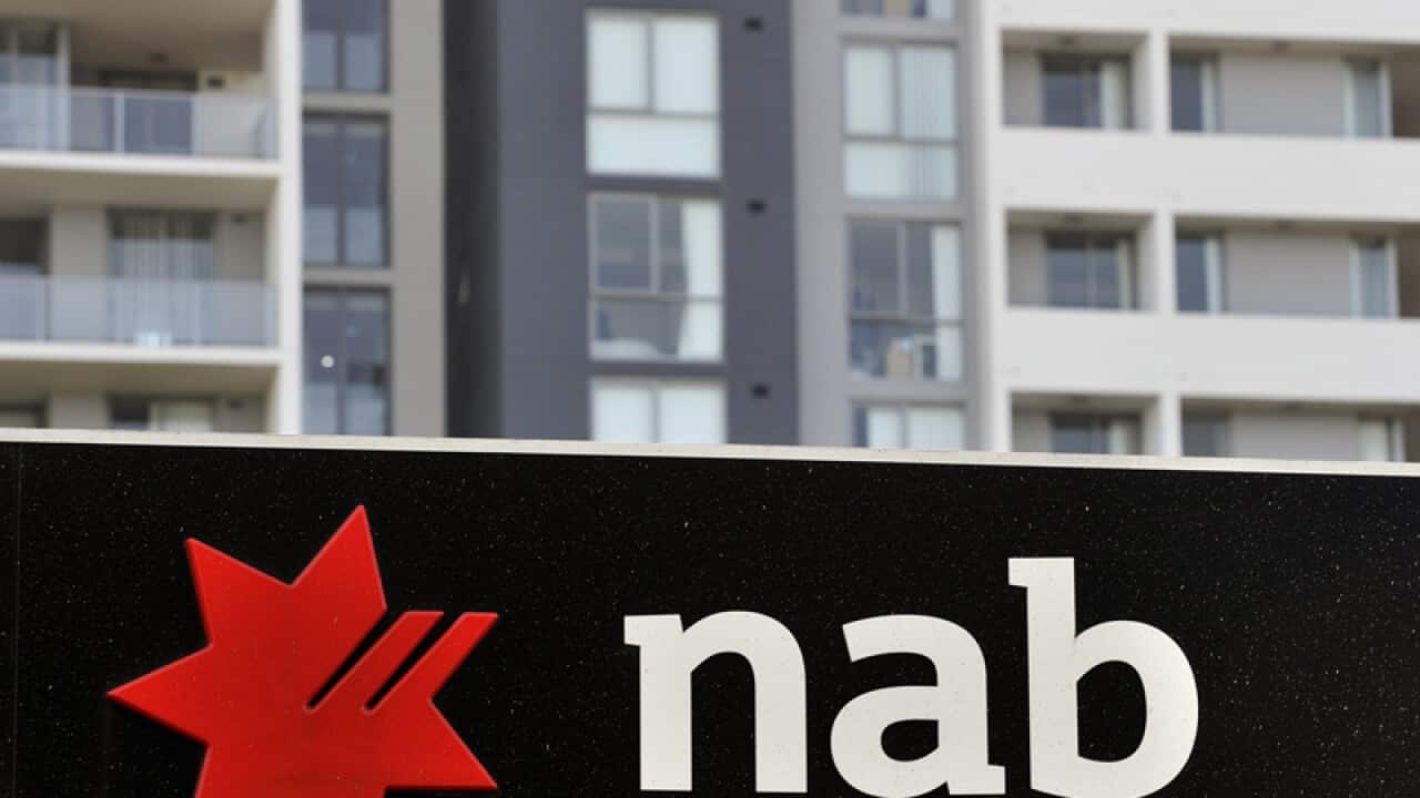 Residential apartment housing seen behind NAB bank signage