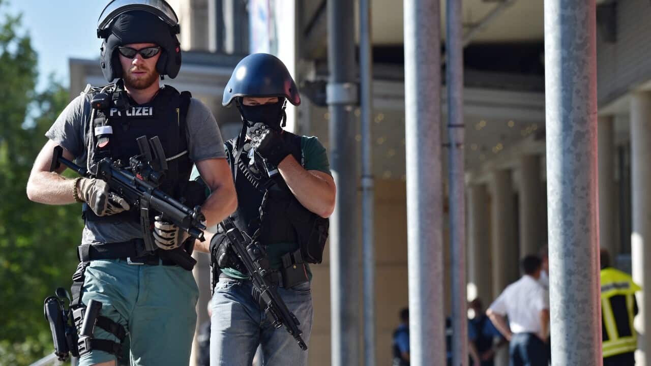 Officers of a special police unit leave the cinema centre in which an armed man had barricaded himself in Viernheim, Germany, 23 June 2016.
