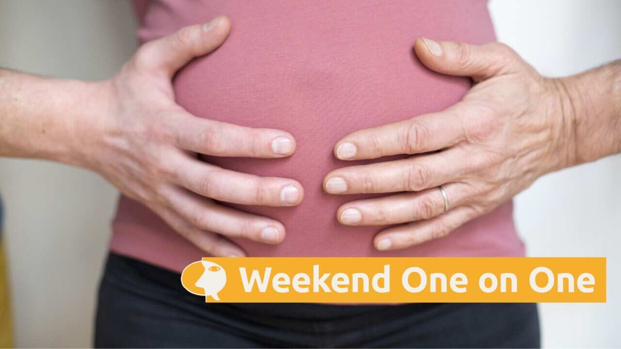 Two hands of different people on the belly of a pregnant woman (Getty).jpg