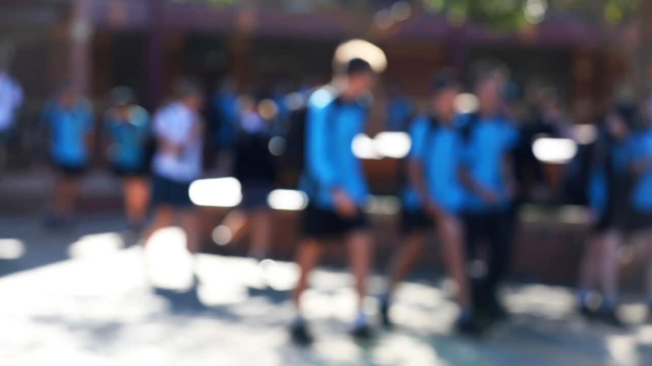 deliberate extreme blur of students to hide identity walking in the school yard chatting between lessons