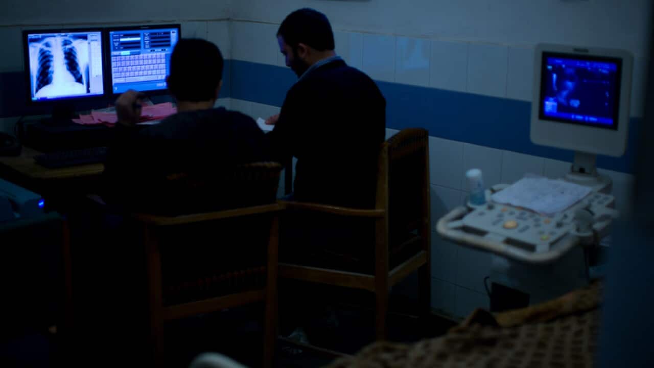 Clinicians looking at a lung x-ray